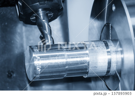 Close-up of a flat nose end mill tool performing a milling process on an NC lathe machine for precision component manufacturing. 137893903