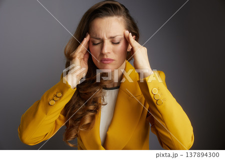 Focused Businesswoman with Intense Headache Focused Businesswoman with Intense Headache 137894300