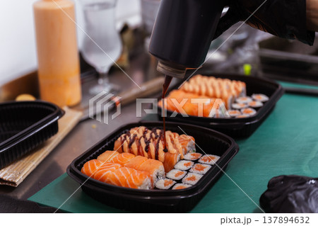 Chef Glazing Sushi With Dark Unagi Sauce Using Squeeze Bottle And Torch, Glossy Finish Chef Glazing Sushi With Dark Unagi Sauce Using Squeeze Bottle And Torch, Glossy Finish 137894632