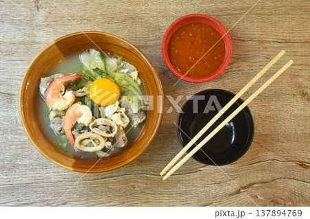 boiled sukiyaki seafood chicken and pork meat couple squid and shrimp with vegetable in soup on bowl dipping sauce 137894769