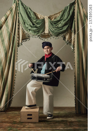 Teen boy playing snare drum on stage studio performance rhythm music portrait. 137895163