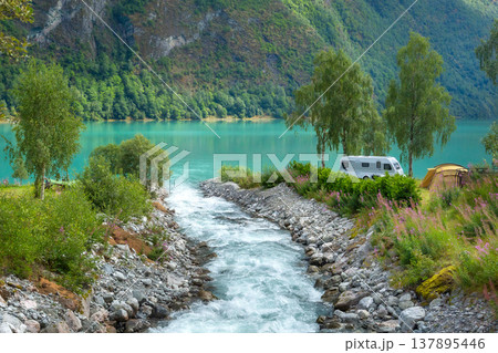 campsite with a camper van and tent by a turquoise fjord in Olden, Norway campsite with a camper van and tent by a turquoise fjord in Olden, Norway 137895446