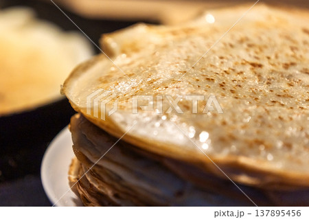 Stack of homemade crepes and frying pan 137895456