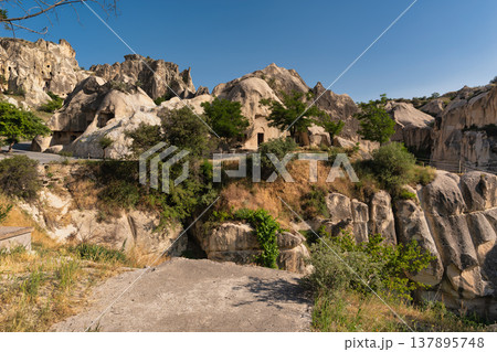 Fairy chimneys and ancient cave dwellings in the unique landscape of Cappadocia, Goreme, Turkey 137895748