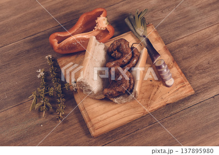 Cow bowels presented on a wooden board with ingredients, ready to grill Cow bowels presented on a wooden board with ingredients, ready to grill 137895980
