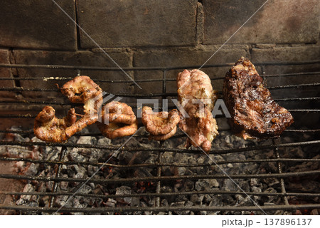 Cow bowels presented on a grill. Argentine Traditional cuisine. Cow bowels presented on a grill. Argentine Traditional cuisine. 137896137