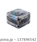 Compact cube-shaped electronic device with transparent casing revealing internal circuit boards and illuminated components. 137896542