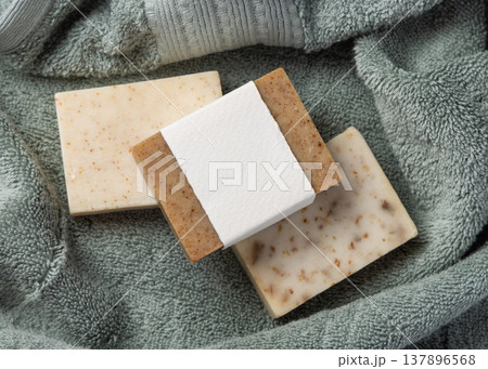 Handmade solid soap bars mockup with blank paper label on sage green bath towel, unbranded packaging Handmade solid soap bars mockup with blank paper label on sage green bath towel, unbranded packaging 137896568