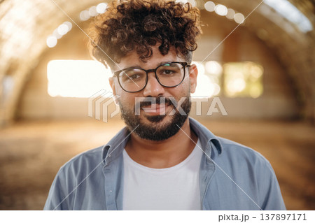 Cheerful man in glasses is in hangar Cheerful man in glasses is in hangar 137897171