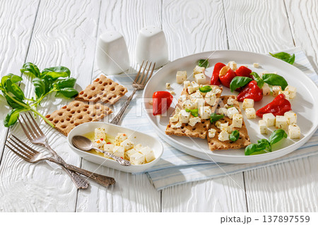 Rye crispbread open sandwich with feta and peppers Rye crispbread open sandwich with feta and peppers 137897559