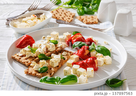 Rye crispbread open sandwich with feta and peppers Rye crispbread open sandwich with feta and peppers 137897563