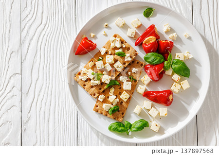 Rye crispbread open sandwich with feta and peppers 137897568