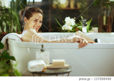 Happy Woman Enjoying a Relaxing Bubbly Bath Happy Woman Enjoying a Relaxing Bubbly Bath 137898490