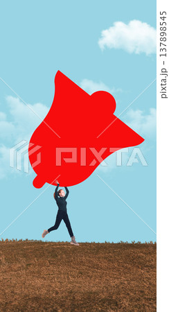 Woman running on dry hill holding oversized abstract bell shaped object against blue sky. Woman running on dry hill holding oversized abstract bell shaped object against blue sky. 137898545