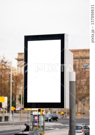Blank vertical digital street screen with white copy space in an urban outdoor setting, ideal for advertising, signage mockups, transit promotions, and modern city campaigns 137898631