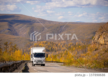 White japanese van moving by a mountain road White japanese van moving by a mountain road 137898686
