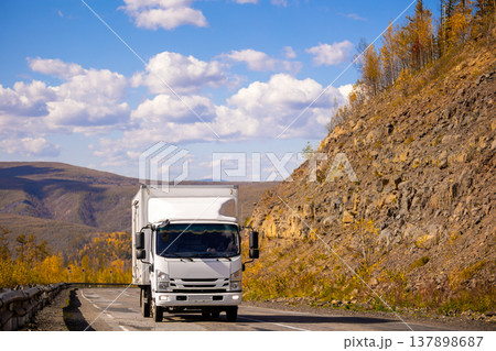 White japanese van moving by a mountain road White japanese van moving by a mountain road 137898687
