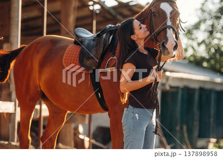 Non urban country scene. Woman is with horse on the farm Non urban country scene. Woman is with horse on the farm 137898958