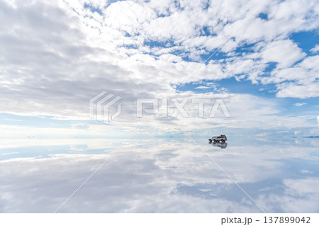 Serene landscape car reflection on vast salt flat in Uyuni Bolivia 137899042