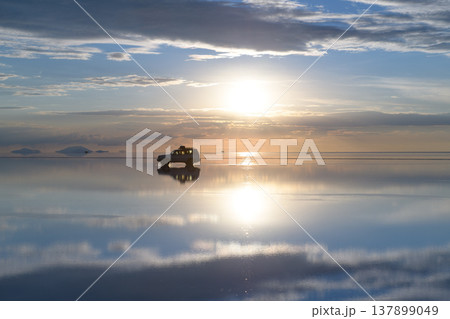 Serene sunrise reflection with car on Uyuni salt flat in Bolivia Serene sunrise reflection with car on Uyuni salt flat in Bolivia 137899049