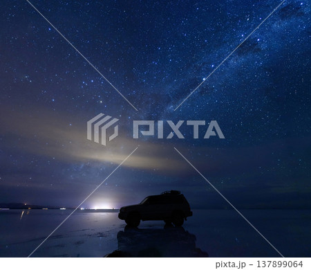 Majestic car silhouette at night with sky reflection in Uyuni Bolivia 137899064