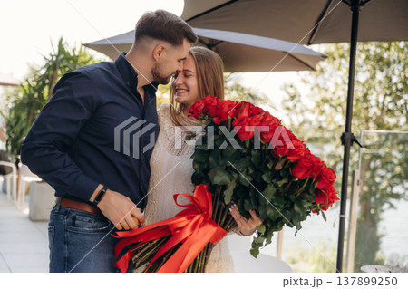 Embracing each other. Boyfriend gifted beautiful flowers to his girlfriend 137899250