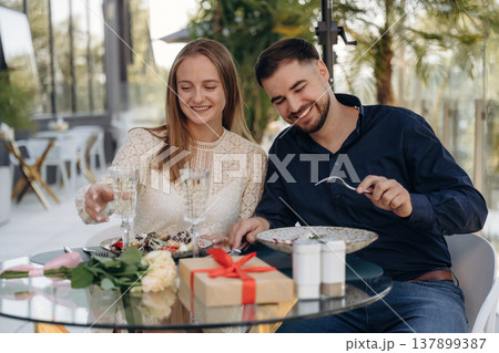 Sitting and enjoying date in the outdoor restaurant, lovely couple 137899387
