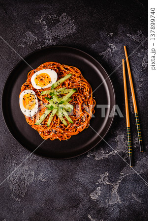 Korean traditional food, cucumber and boiled egg cold spicy noodles. Korean traditional food, cucumber and boiled egg cold spicy noodles. 137899740
