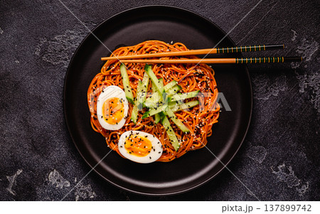 Korean traditional food, cucumber and boiled egg cold spicy noodles. 137899742