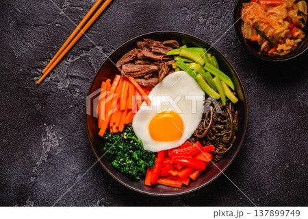 Traditional Korean dish Bibimbap: rice with vegetables beef and egg. 137899749