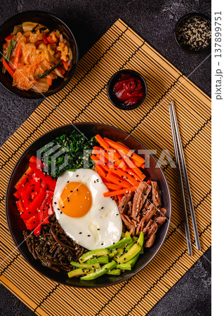 Traditional Korean dish Bibimbap: rice with vegetables beef and egg. Traditional Korean dish Bibimbap: rice with vegetables beef and egg. 137899751