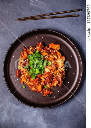 Fried kimchi with pork onions and spices. Traditional Korean food Fried kimchi with pork onions and spices. Traditional Korean food 137899766