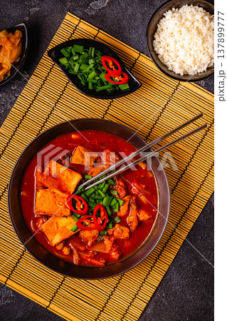 Korean traditional food, spicy kimchi soup (kimchi tige) with pork and tofu cheese. Korean traditional food, spicy kimchi soup (kimchi tige) with pork and tofu cheese. 137899777