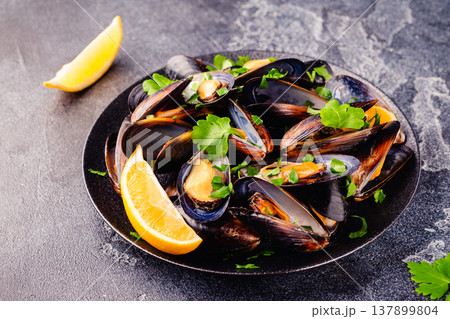 Delicious seafood mussels with sauce and parsley. Delicious seafood mussels with sauce and parsley. 137899804