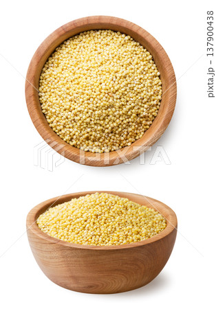 Full plate of millet seeds and a top view close-up on a white background. Isolated Full plate of millet seeds and a top view close-up on a white background. Isolated 137900438