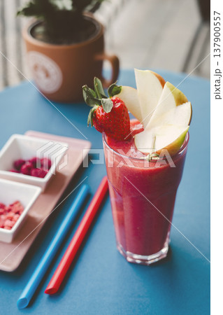 Strawbery smooties in the glass on the table 137900557