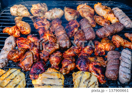 grilled meat over the coals on barbecue 137900661