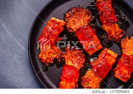 Bacon roll with enoki mushroom grilled with sauce. Bacon roll with enoki mushroom grilled with sauce. 137900665