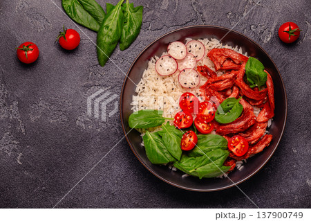 Bowl with vegan fried soy meat and vegetables served with boiled rice. Bowl with vegan fried soy meat and vegetables served with boiled rice. 137900749