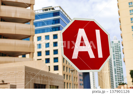 Stop sign with AI written on it placed between tall buildings in a city area during the day Stop sign with AI written on it placed between tall buildings in a city area during the day 137901126