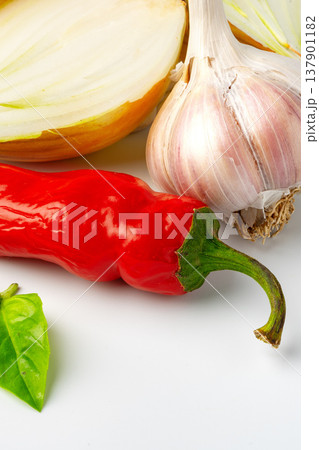 Fresh vegetables for cooking in a kitchen setting with a focus on garlic and chili pepper Fresh vegetables for cooking in a kitchen setting with a focus on garlic and chili pepper 137901182