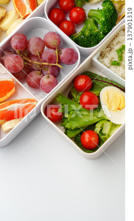 Healthy lunch box filled with fruits, vegetables, and rice during midday meal time Healthy lunch box filled with fruits, vegetables, and rice during midday meal time 137901319