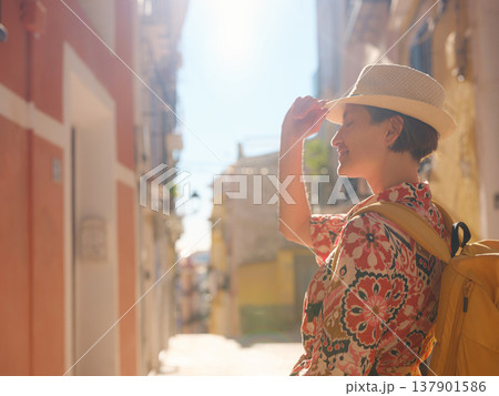 Woman strolls through colorful streets of Spanish coastal town 137901586