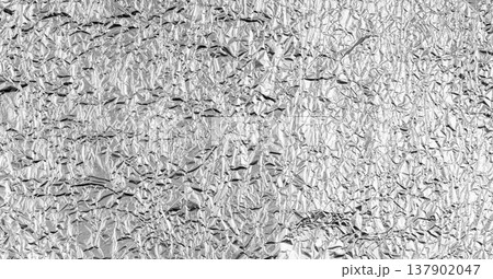 Textured metallic surface with glossy platinum shine and dynamic wrinkles creates an abstract Textured metallic surface with glossy platinum shine and dynamic wrinkles creates an abstract 137902047
