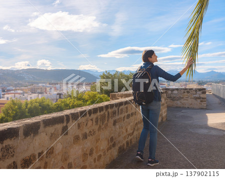 Young woman exploring historic castle in Denia Young woman exploring historic castle in Denia 137902115