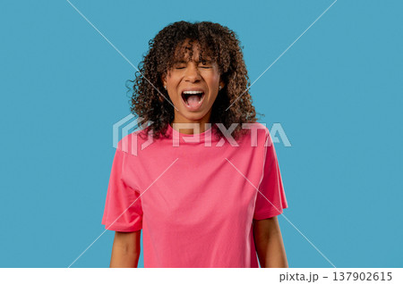 Angry African Teenage girl Yelling At Camera With Expressive Face In Frustration Angry African Teenage girl Yelling At Camera With Expressive Face In Frustration 137902615