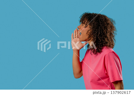 Attention, Portrait Of Young Woman Shouting, Holding Hand Near Open Mouth Attention, Portrait Of Young Woman Shouting, Holding Hand Near Open Mouth 137902617
