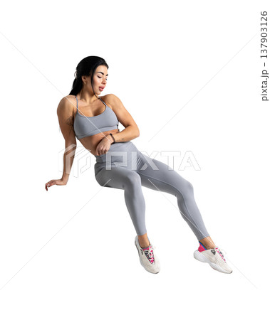 Athletic woman with a strong body wearing an activewear set on a white background Athletic woman with a strong body wearing an activewear set on a white background 137903126