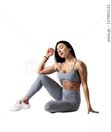 Athletic woman with a strong body wearing an activewear set on a white background 137903132