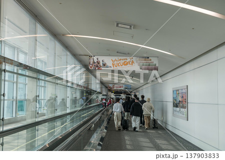 Tourist people walk in Fukuoka airport terminal to immigration Tourist people walk in Fukuoka airport terminal to immigration 137903833